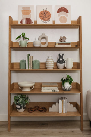 A modern shelf styled with a collection of unique modern decor.