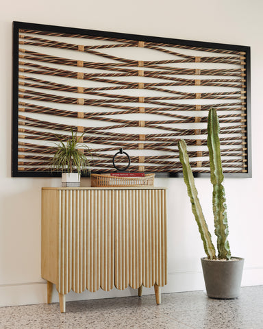 Modern hallway with reeded storage cabinet and decor.