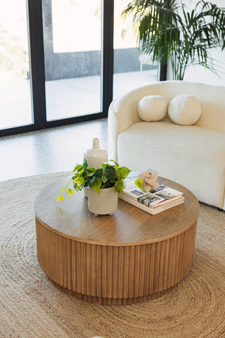 Modern reeded coffee table styled with books and decor.