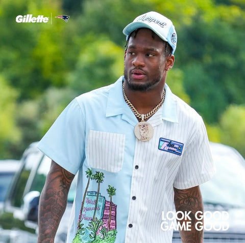 New England Patriots Linebacker, Mack Wilson Sr. seen wearing the Hotel Striped Doodle Shirt in sky blue & white. Oversized fit with elegant accents to finish the garment including our multi-color silicone patch at wearer's left chest, sublimated graphic at wearer's right bodice, and buttons at center front closure.(via New England Patriots IG Post, @patriots)