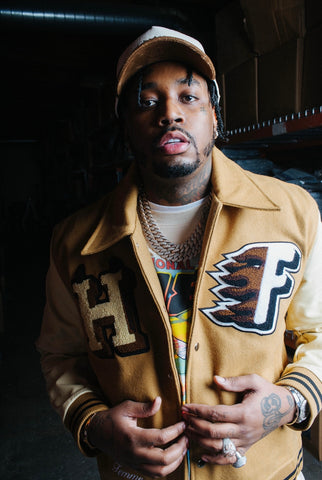 Rapper, Five Foreign seen wearing the Homme Femme World Champs Letterman Jacket and Chateau Corduroy Hat.