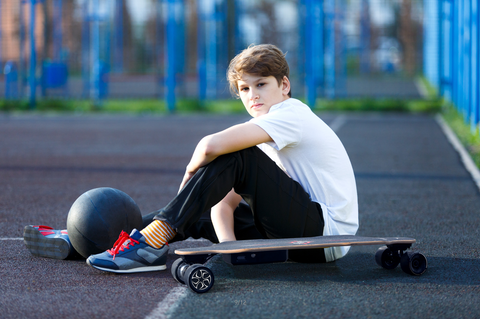 kid and electric skateboard