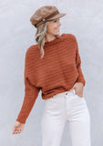 [Color: Burnt Orange] A blonde model wearing a fuzzy dark orange boatneck sweater. The wide neckline can be worn off the shoulder.  