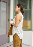 [Color: Mist] A model wearing a classic linen blend tank top. Featuring a racer back, a crew neckline, a round hemline, and a center seam along the back.