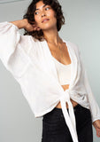[Color: Ivory] A front facing image of a brunette model wearing an ivory white bohemian embroidered chiffon kimono top. With long sleeves and a tie front that can be styled in multiple ways. 