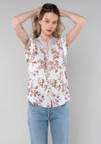 [Color: Mint/Rose] A front facing image of a blonde model wearing a spring bohemian top in a light mint and rose pink mixed floral print. With short flutter sleeves, a self covered button front, a ruffled neckline with ties, and a relaxed fit. 