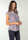 [Color: Grey/Natural] A side facing image of a brunette model wearing a best selling Helpone clickaway button front top in a grey and natural floral print. With short flutter sleeves and a ruffled neckline. 