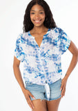 [Color: Navy/Teal] A front facing image of a black model wearing a blue and white watercolor floral print short sleeve top with a button front and a tie front detail at the waist. 