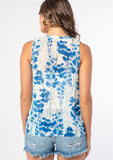 [Color: Cream/Blue] A model wearing a sheer chiffon sleeveless bohemian blouse in a white and blue watercolor floral print. 