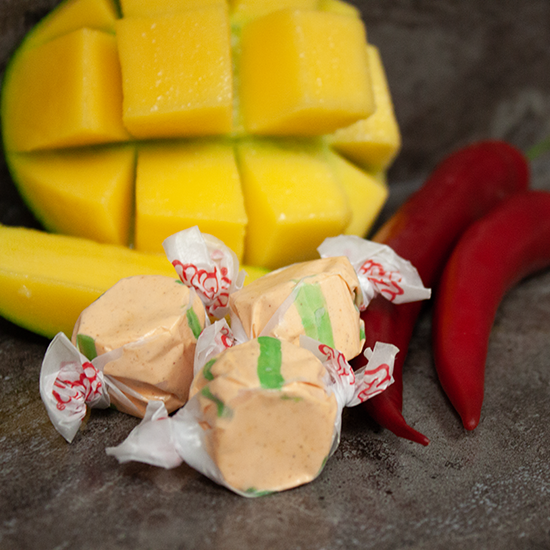 Chili Mango Taffy with Red Chili Peppers and a Yellow Mango