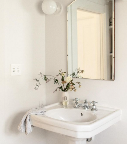 Bathroom mirror with white bathroom sink