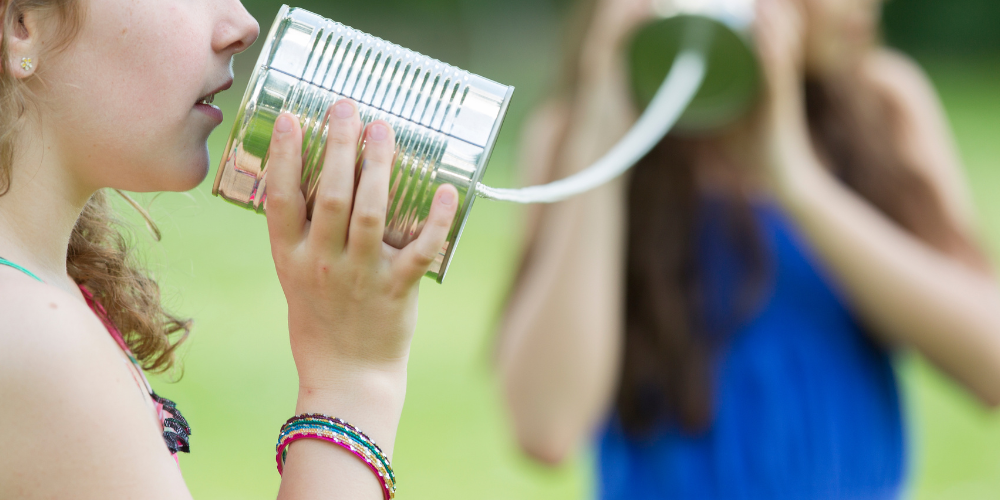 kids playing with tin can phone