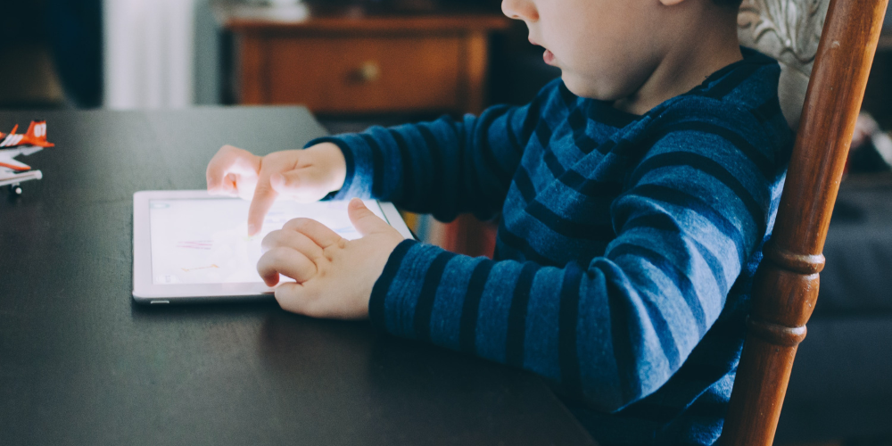 Little child playing on ipad