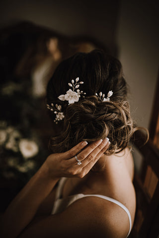 A bride wearing a set of bridal hair pins in a messy updo.