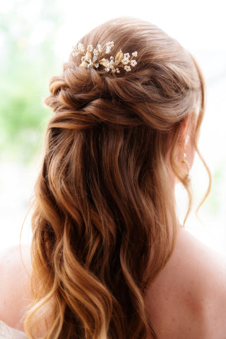 Bride with long hair in a up half down hairstyle with bridal hairpins.