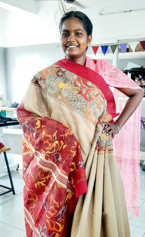 girl standing wearing sari and smiling