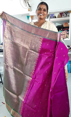 woman standing holding up sari and smiling