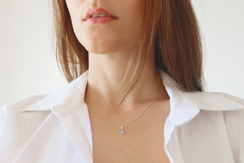 A woman wearing a simple necklace. 