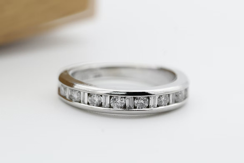A silver anniversary ring with diamonds. 