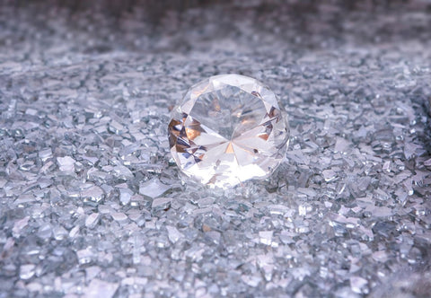  Diamond on top of shattered glass pieces