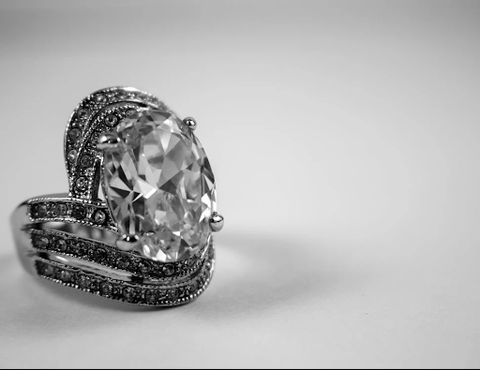 An ornate engagement ring with several diamonds. 