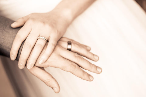  a couple wearing wedding rings