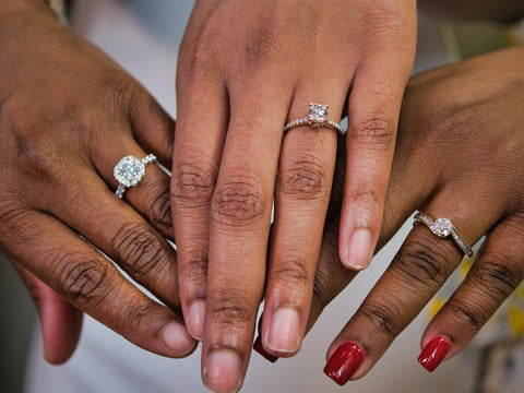  Three women showing off their engagement rings