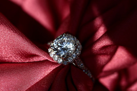 A new diamond ring sitting on a cloth