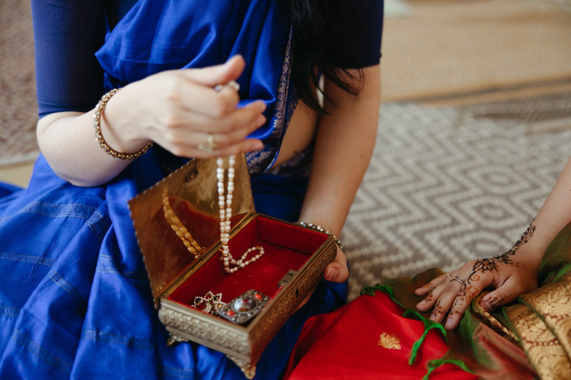 A woman goes through a jewelry box