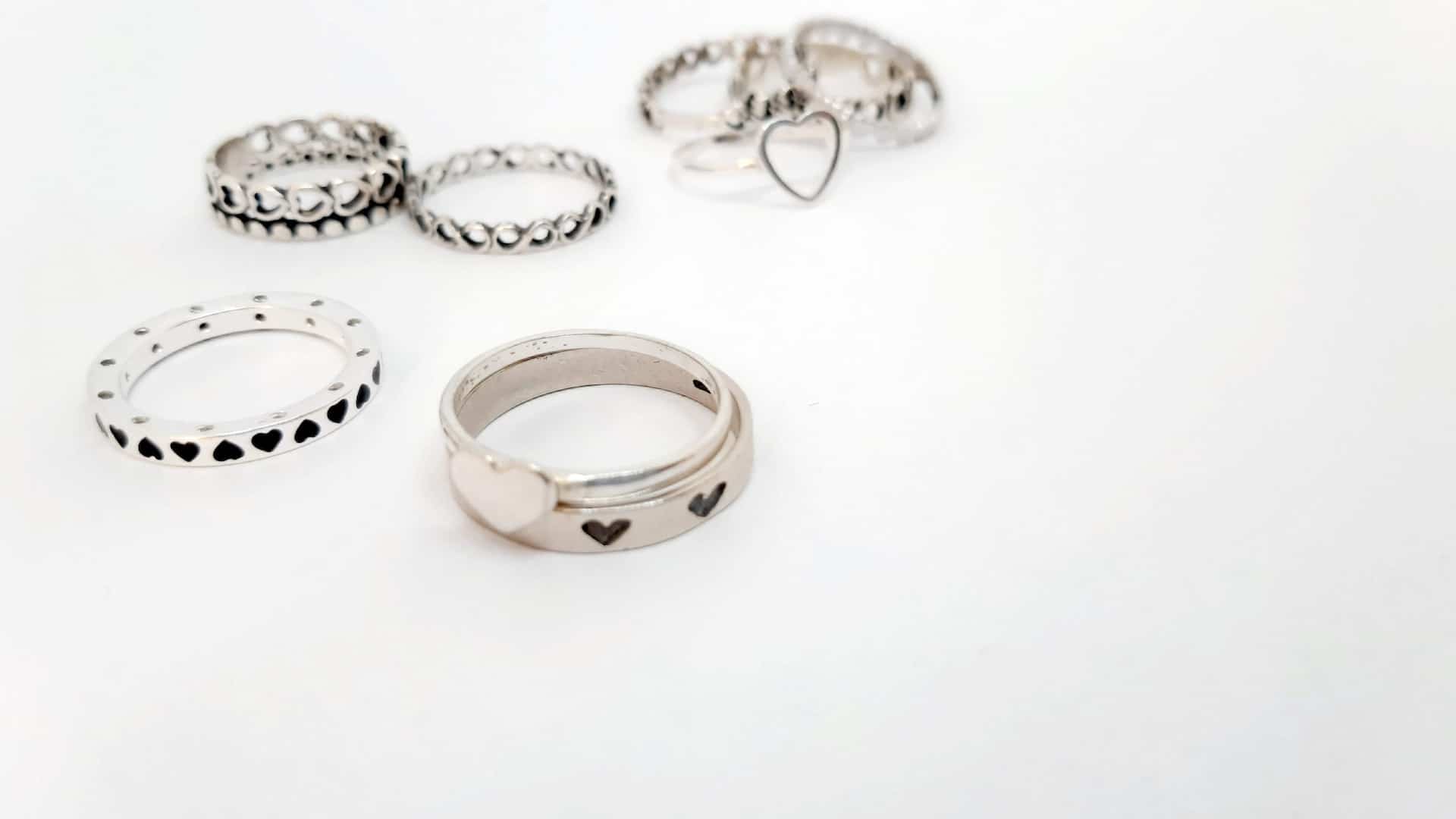 a collection of silver rings that have hearts on them