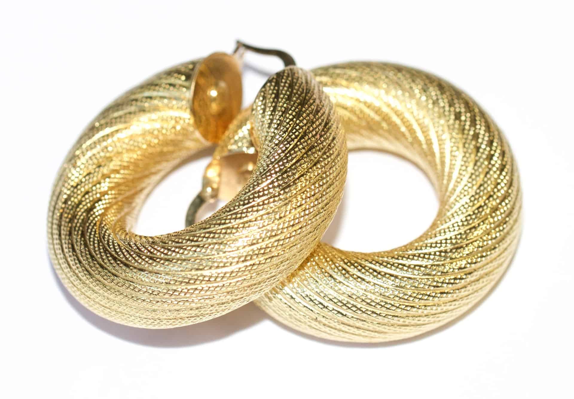 A pair of gold huggies hoop earrings