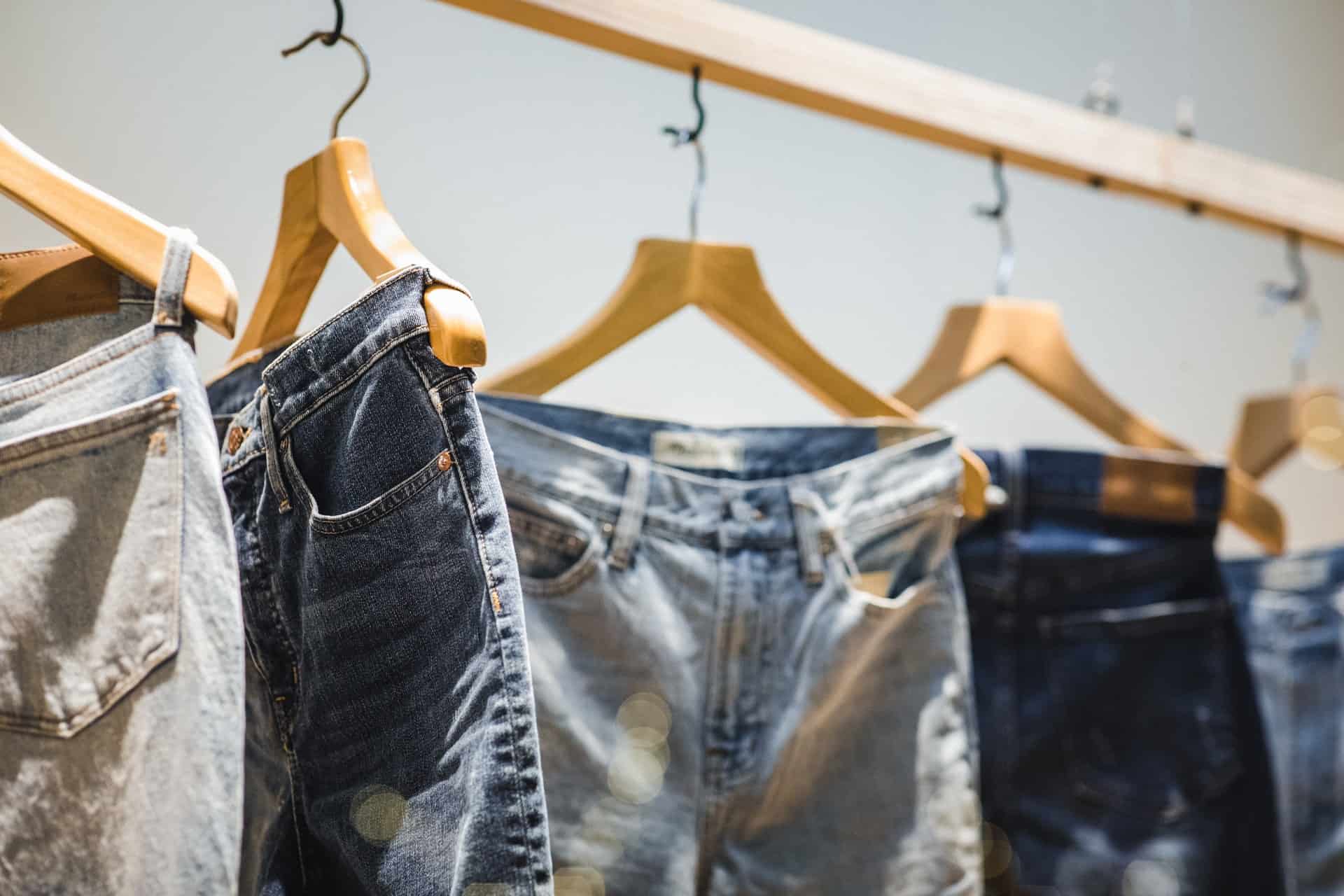jeans hanging on rack
