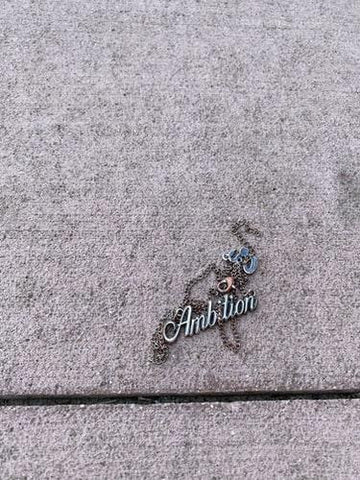 tangled necklace with ambition charm.