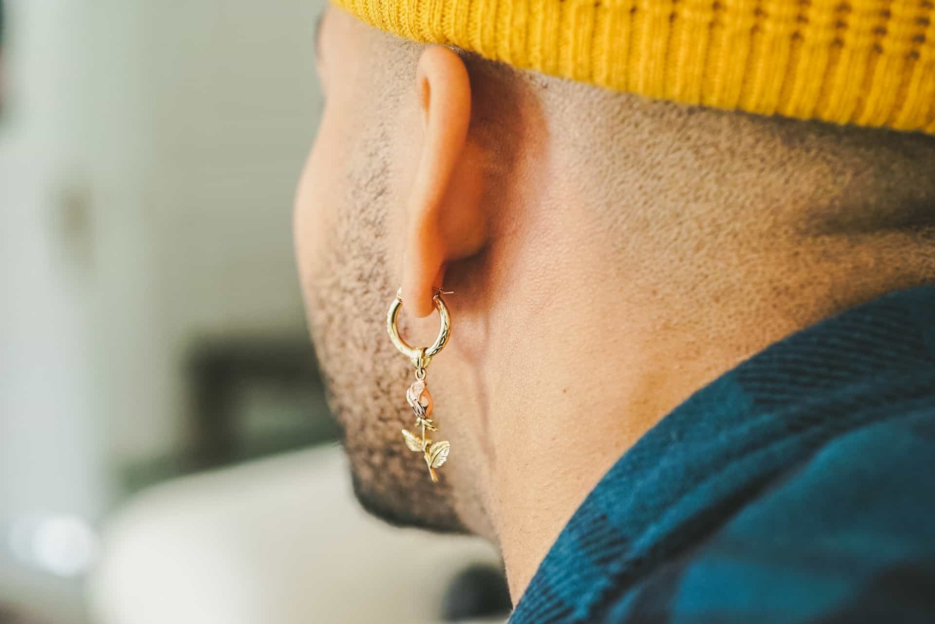 a man with gold earrings