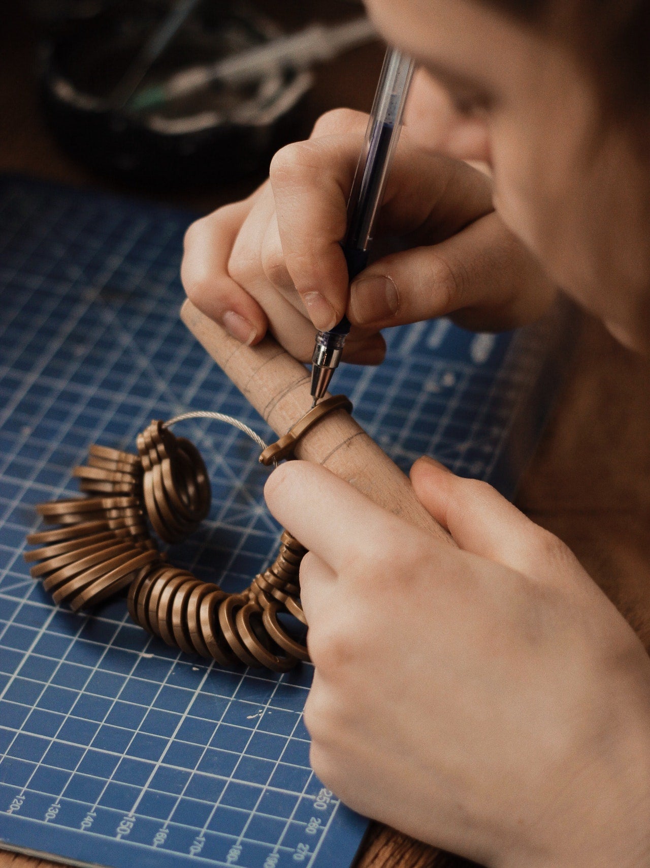 A man using a jeweler's tool for rings