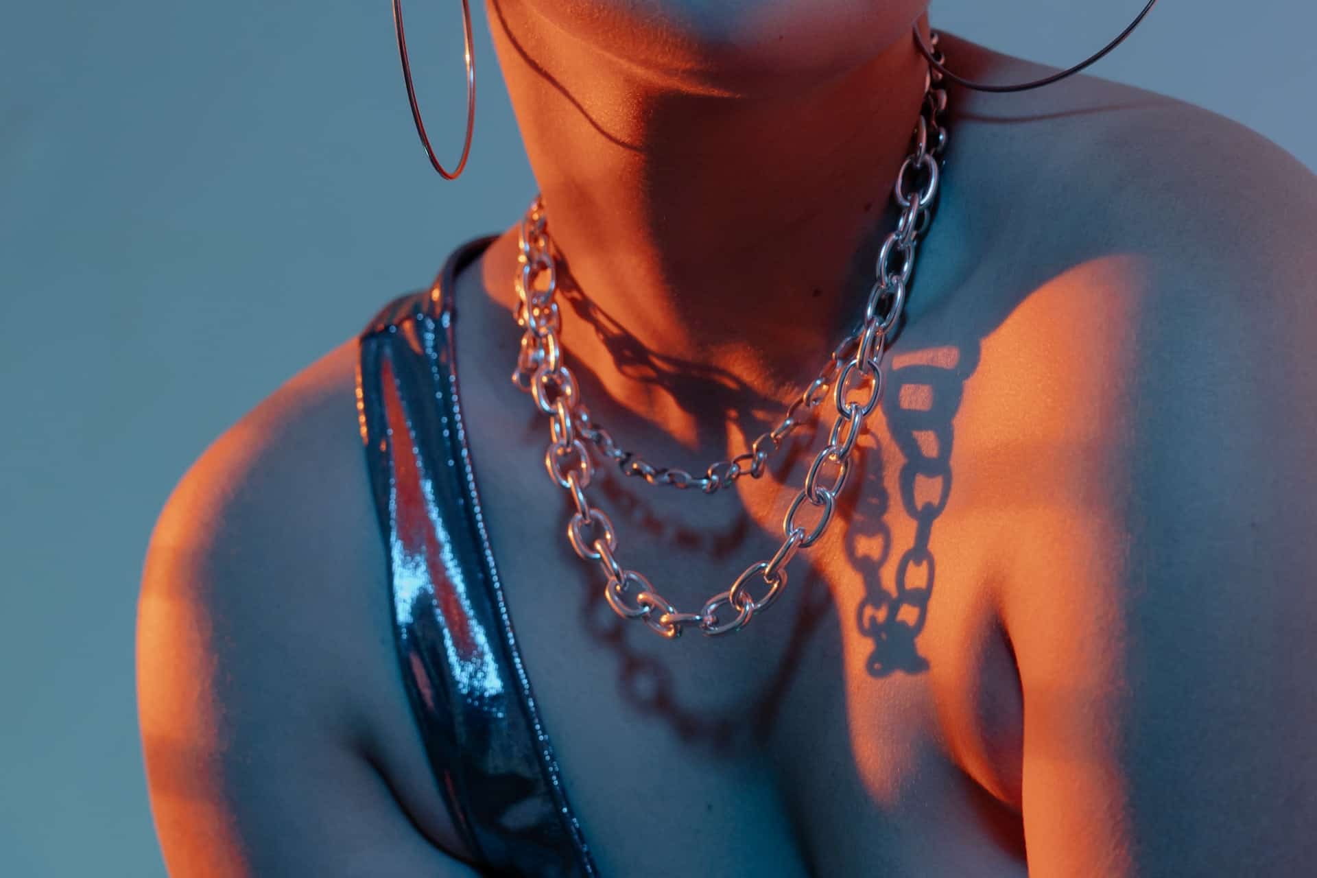 A Women Wearing Chain Necklaces and Hoop Earrings