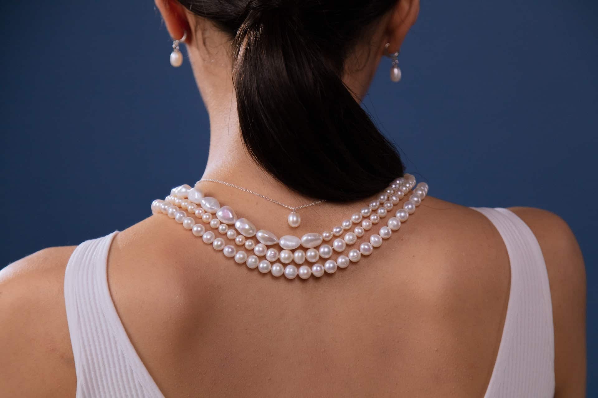 Woman wearing pearl necklaces and earrings