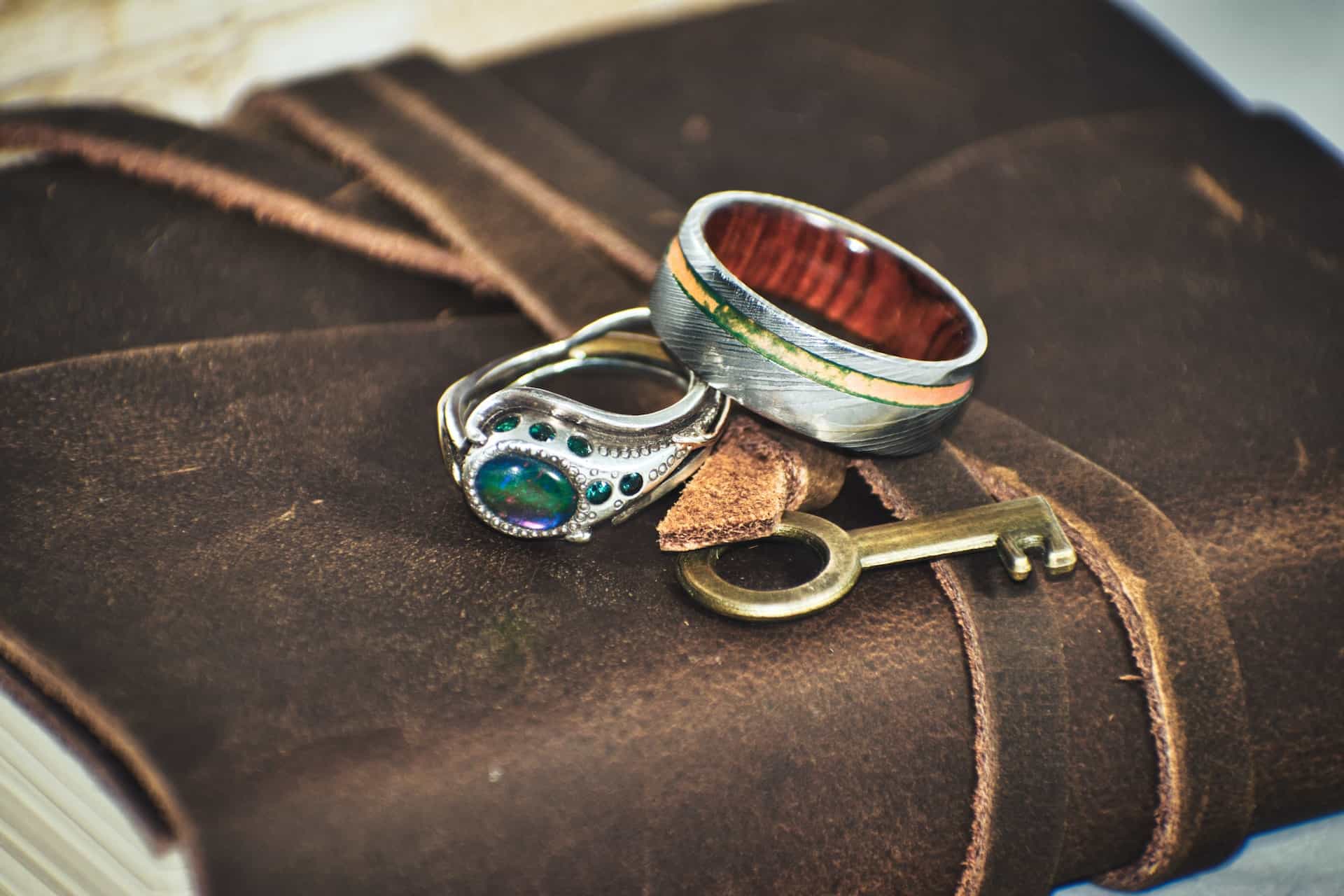 Rings and a Key Sitting on a Leatherbound Book