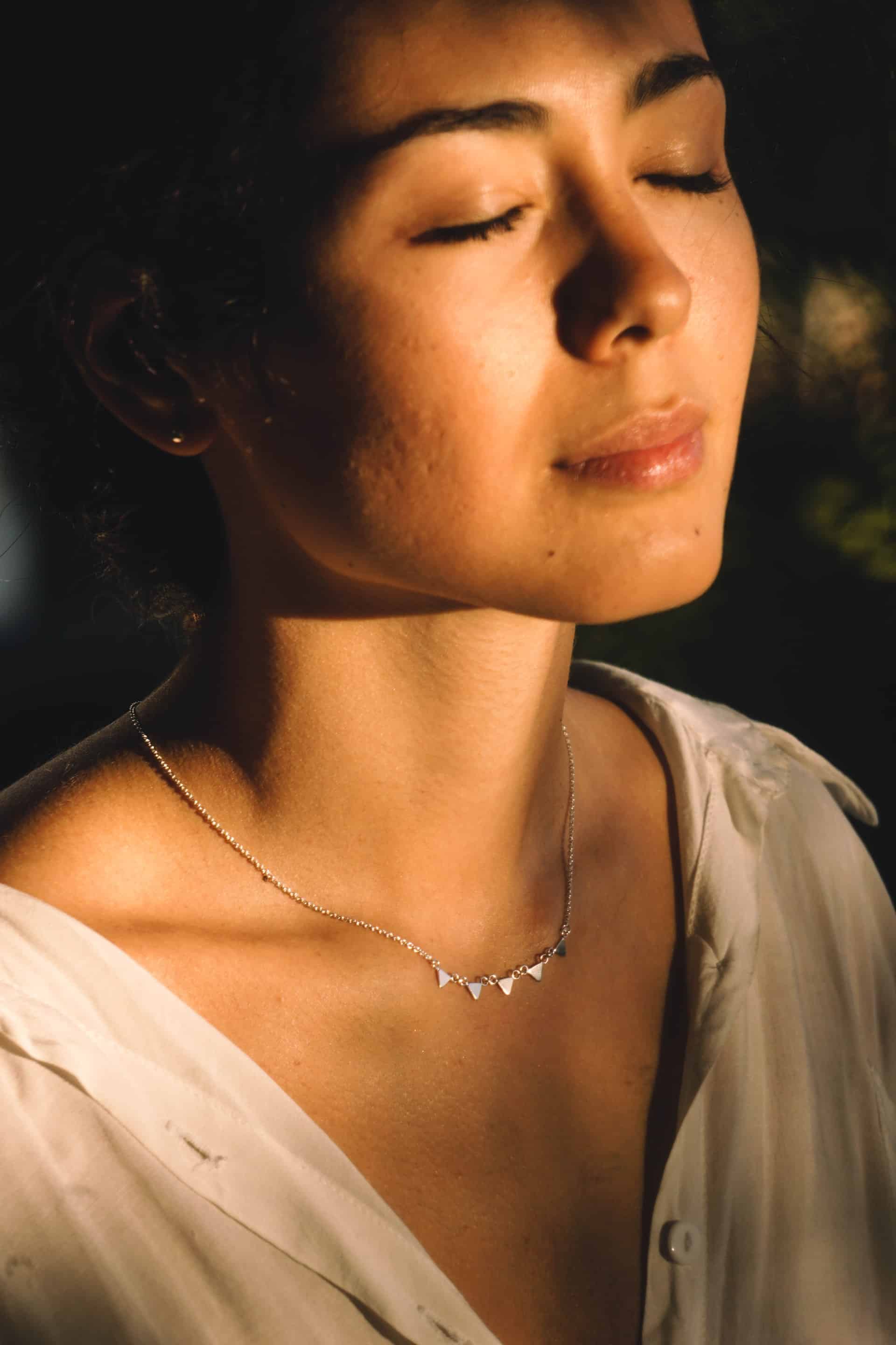 Woman wearing dainty necklace 