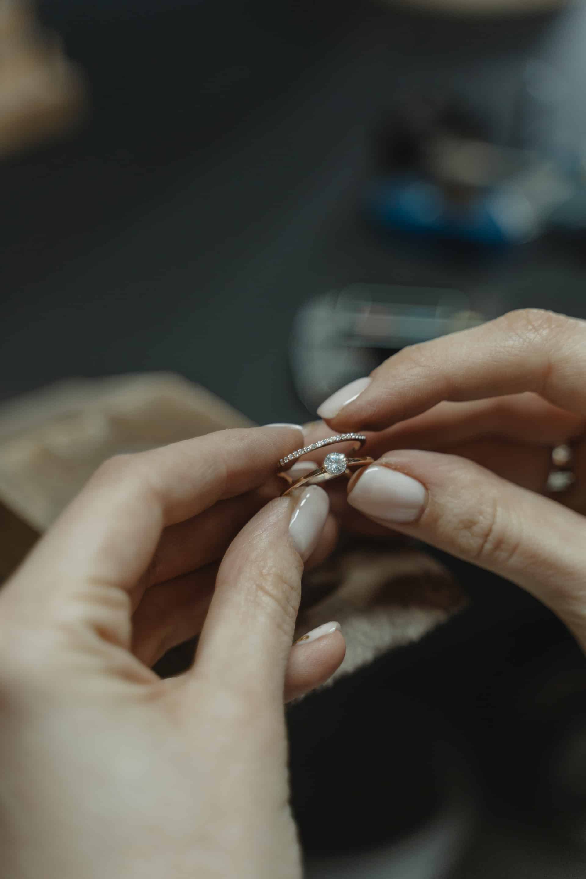 woman holding diamond ring