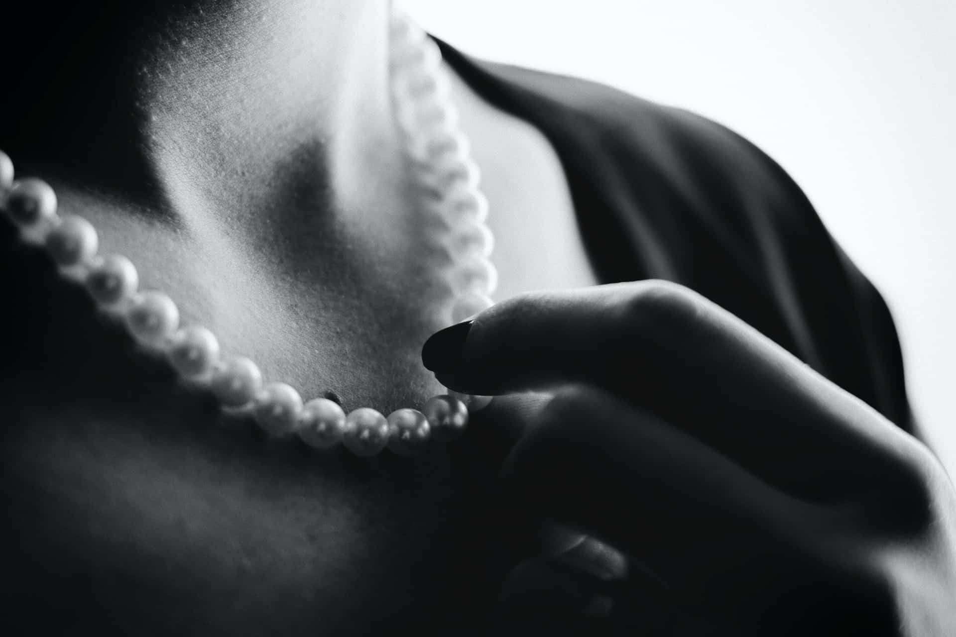 A woman wearing a pearl necklace.