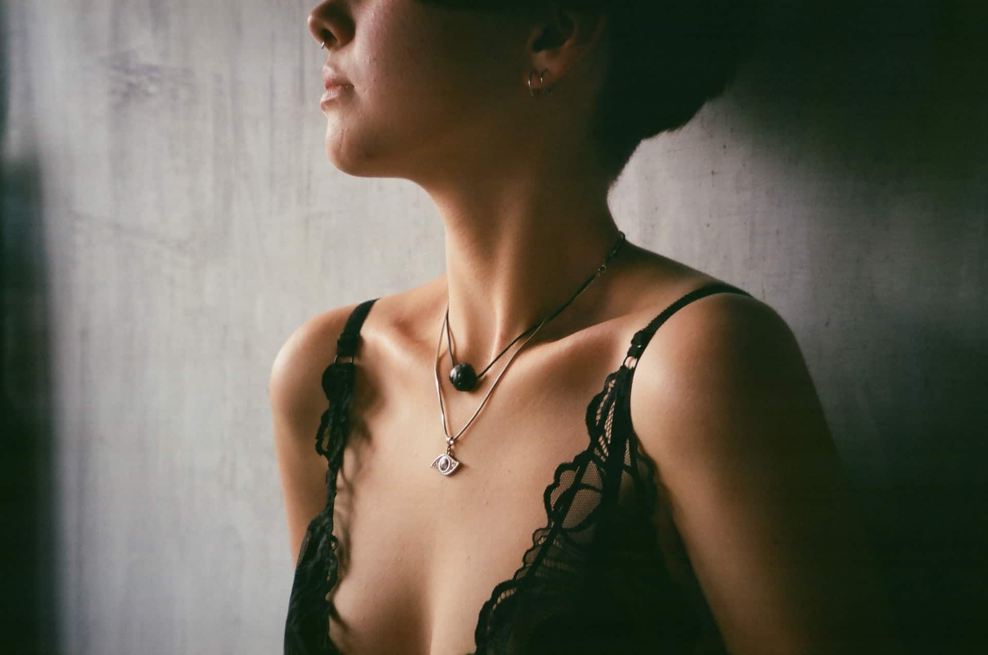 A woman wearing two necklaces. 