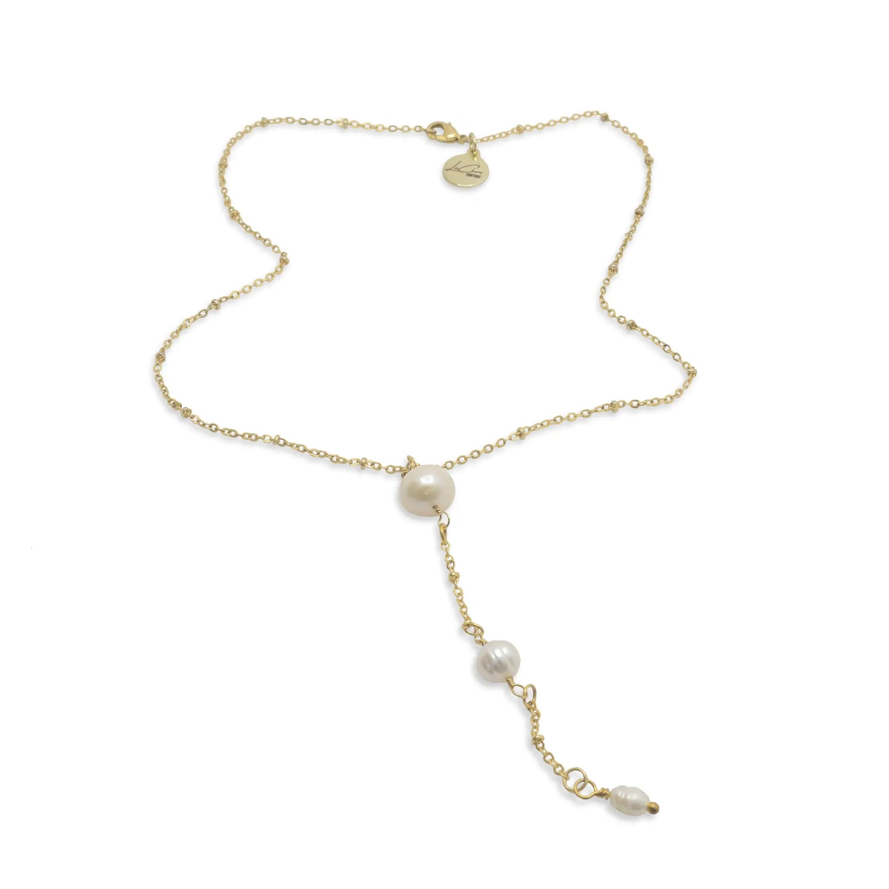 A gold chain with three pearls