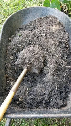 Wheelbarrow full of soil and compost mixture with shovel