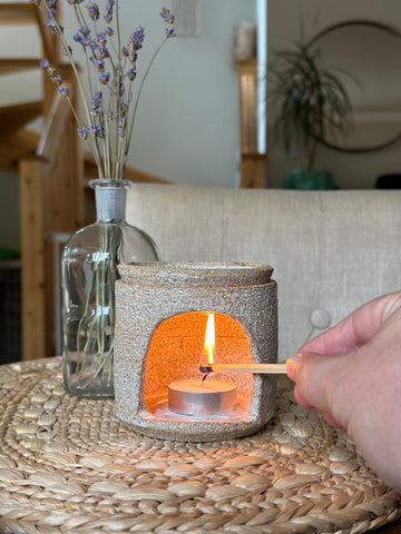 Light a tealight in the bottom of the wax burner.