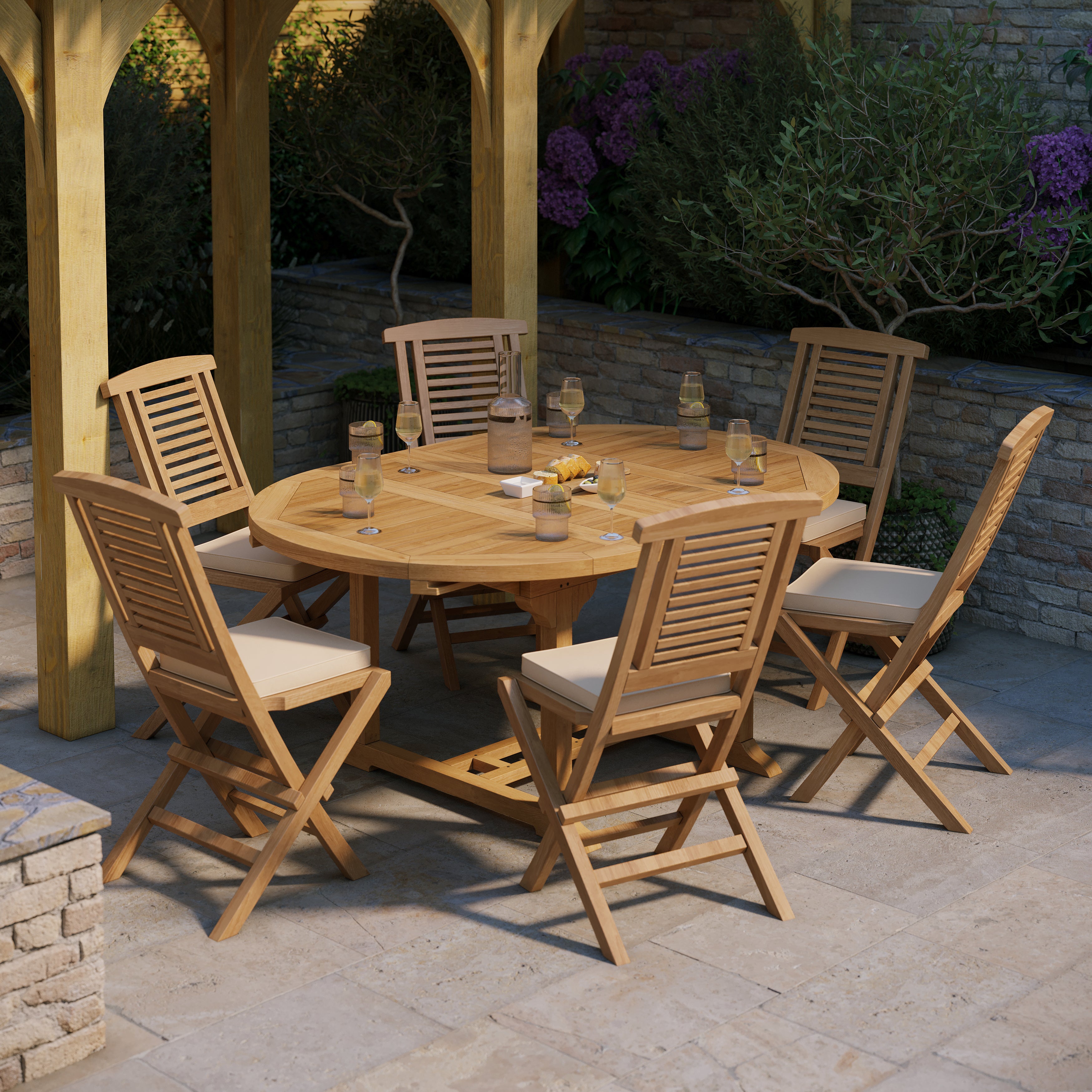 Product photograph of Teak Garden Furniture Round To Oval 120-170cm Extending Table 6 Folding Hampton Chairs Cushions Included from Luxus Home And Garden