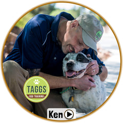 Picture of Ken from Taggs K9 dog training kneeling down and embracing a smiling dog