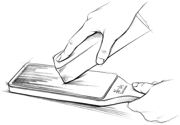 A sketch of a leather strop being loaded with a fine grit polishing compound.