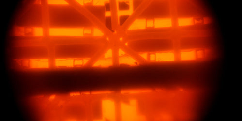 A view into the inside of a forge that is glowing bright orange red.