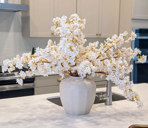 Image of beautiful artificial cherry blossoms in a kitchen. 